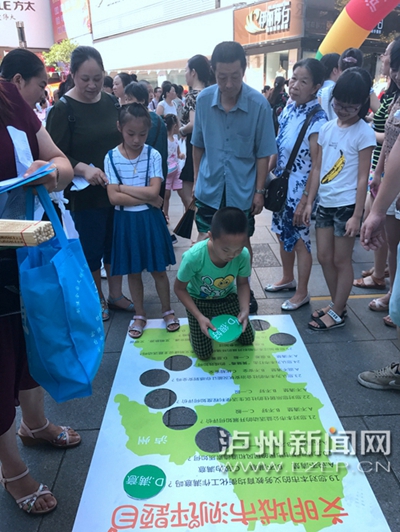 市民在宣傳點(diǎn)參加創(chuàng)文趣味游戲。 記者 朱虹 攝